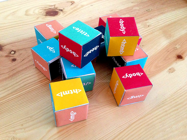 An image of stacked boxes with HTML tags on their sides
